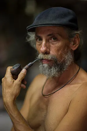 an old man smoking a pipe