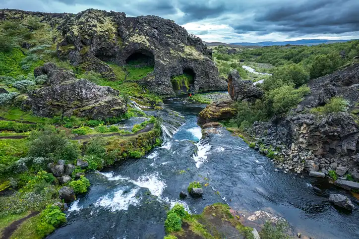 Gjáin waterfall flowing in Þjórsárdalur lush valley during summer at Iceland