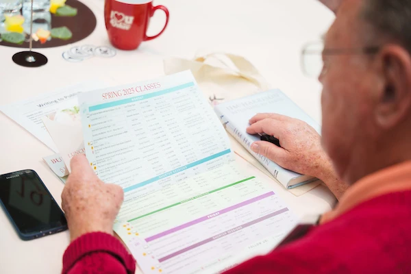 an osher member looking at an osher class schedule