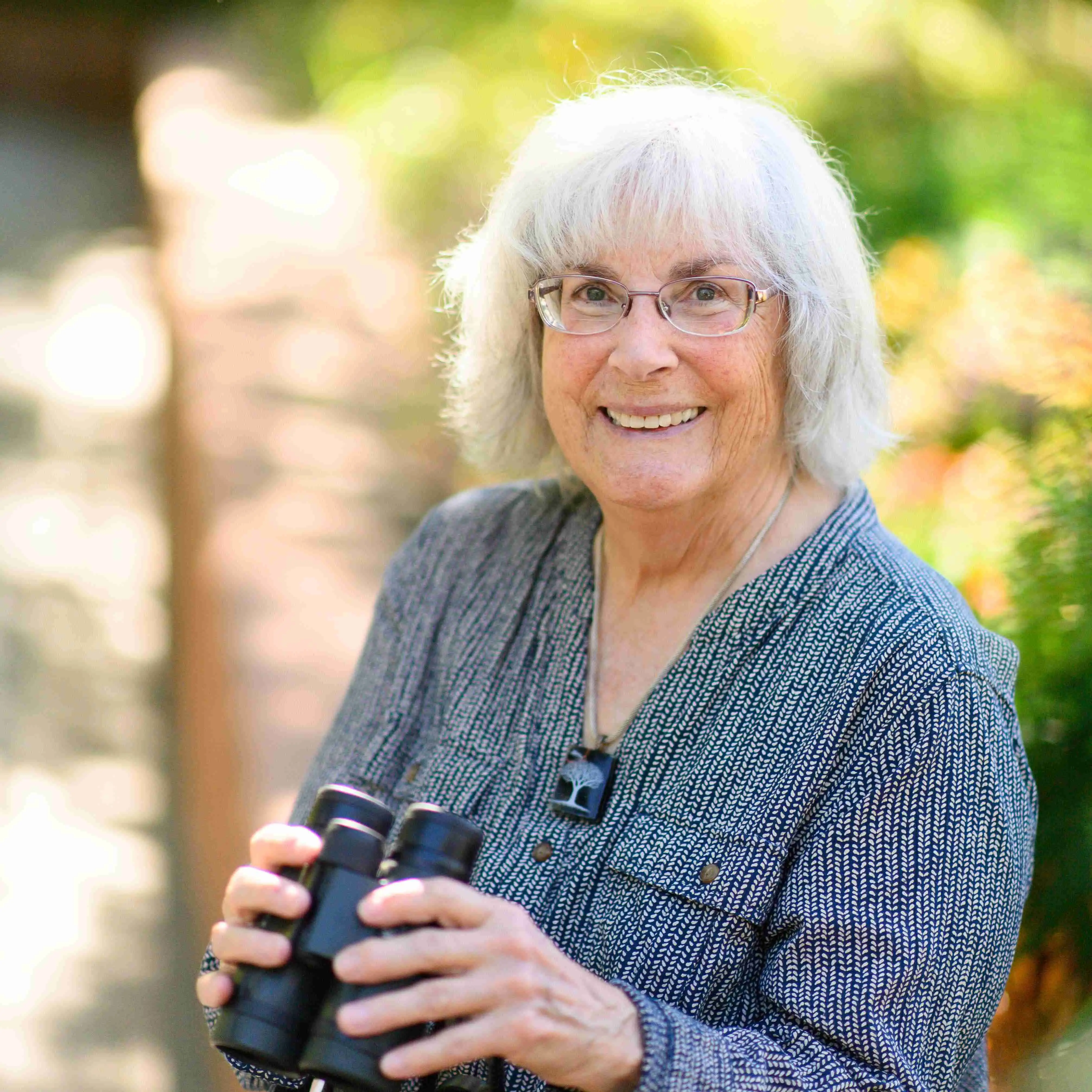an osher member with binoculars