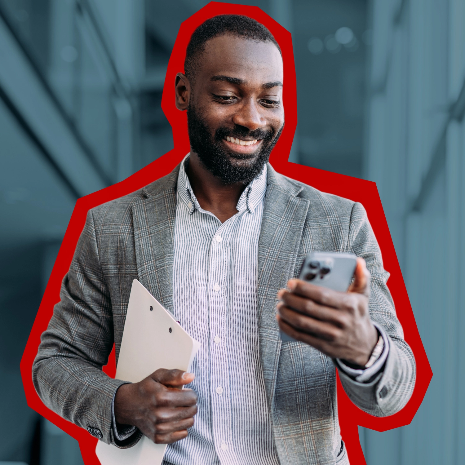 A man carrying a clipboard and smiling at his phone.