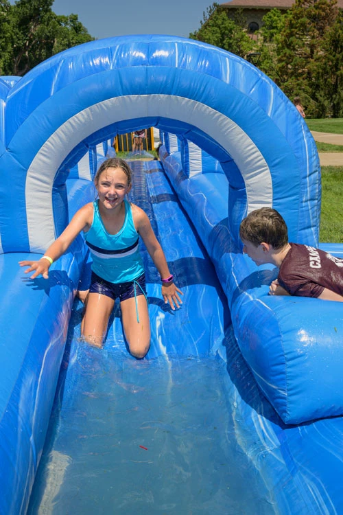 2 kids having fun on a water slide