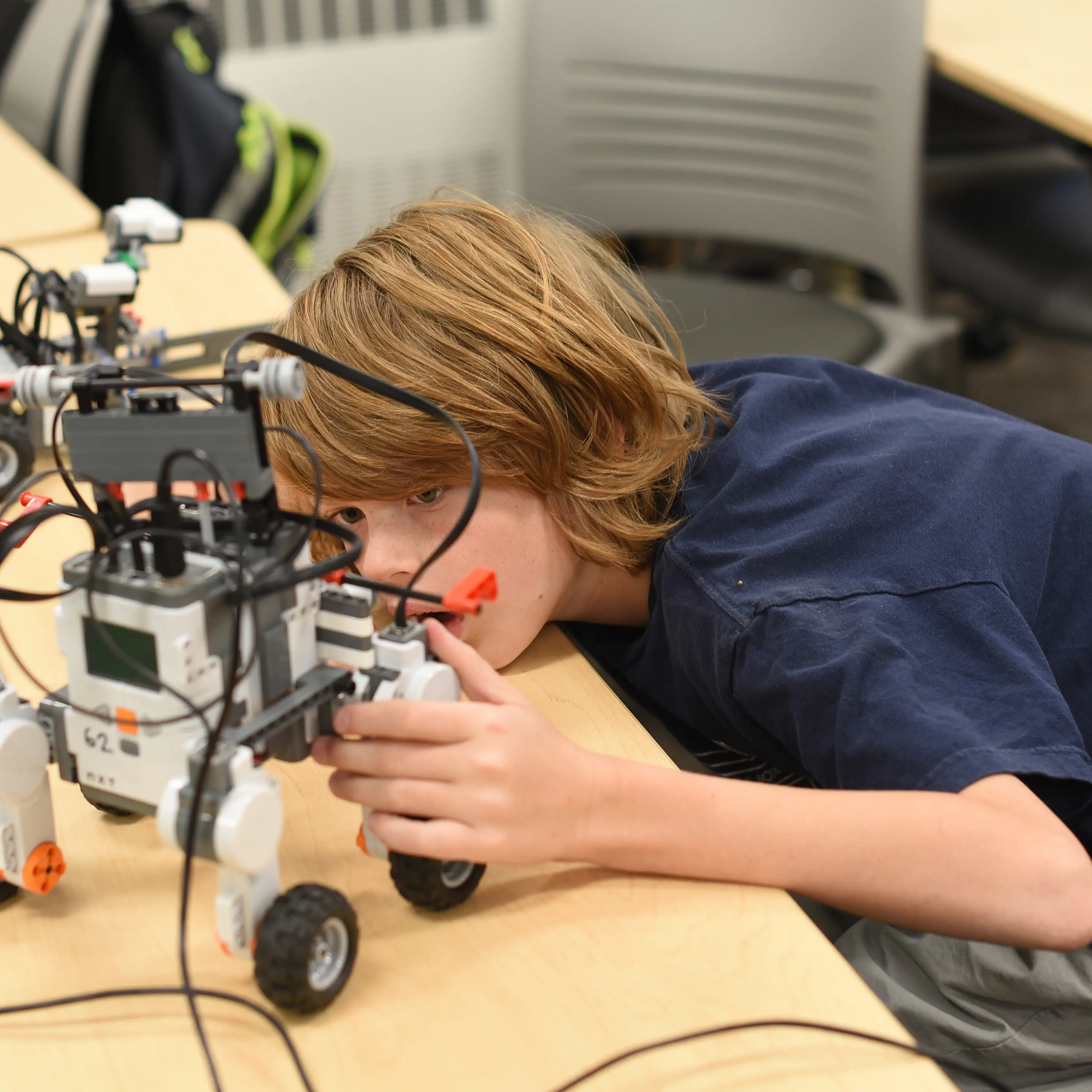 a boy working on his robot
