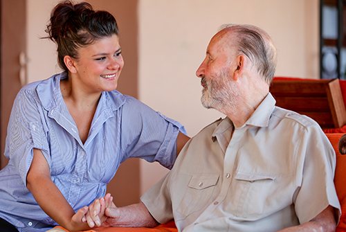 young woman holding older man's hand