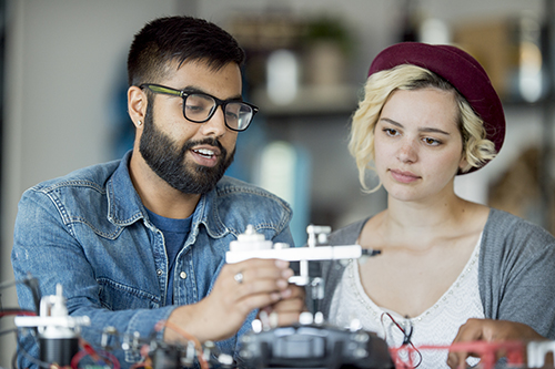 male and female students working on tech project